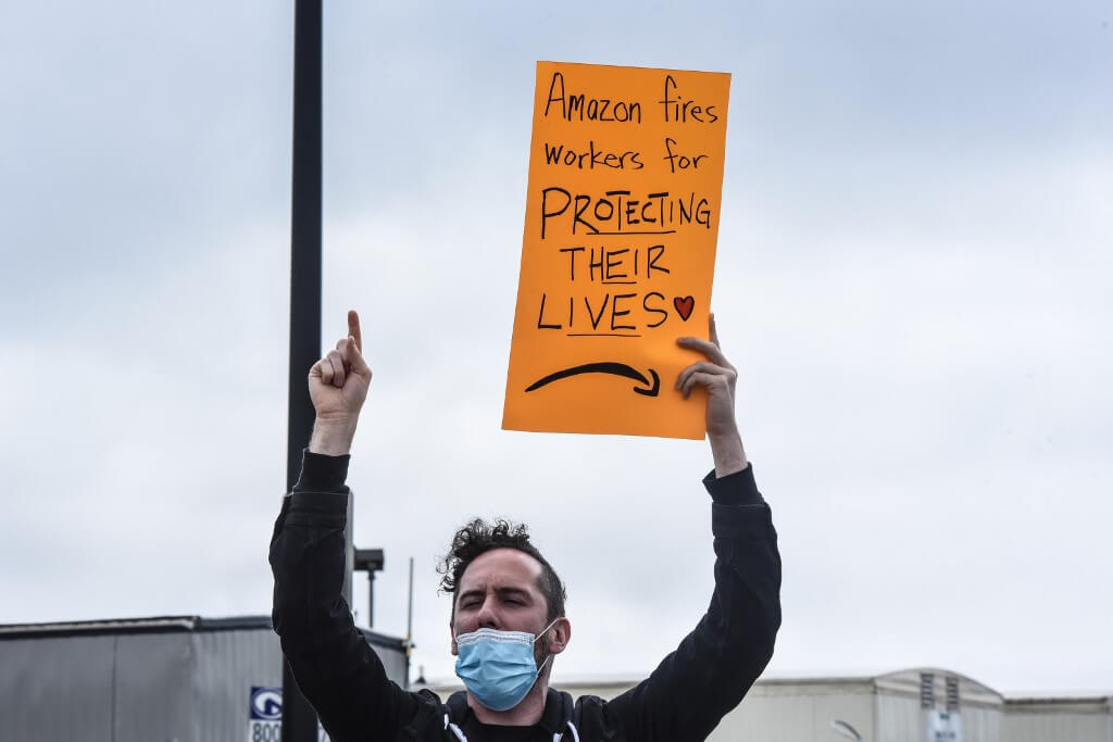 People protest working conditions outside of an Amazon warehouse fulfillment center in New York