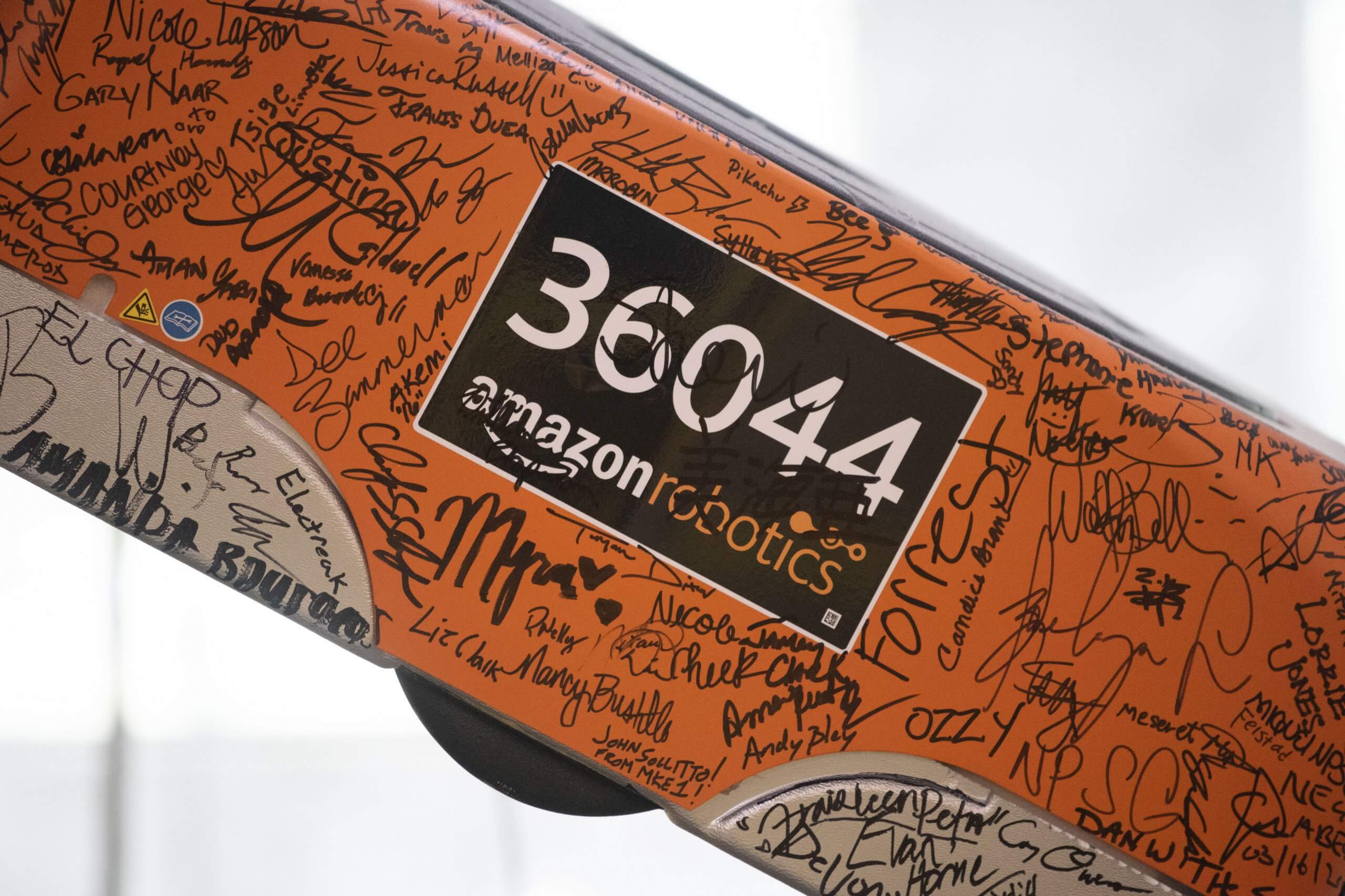 Amazon Robotics works, signed by the entire staff on the opening day of the Kent, Washington Fulfillment Center in March of 2016, hangs over the entrance during a tour September 21, 2018 in Kent, Washington.